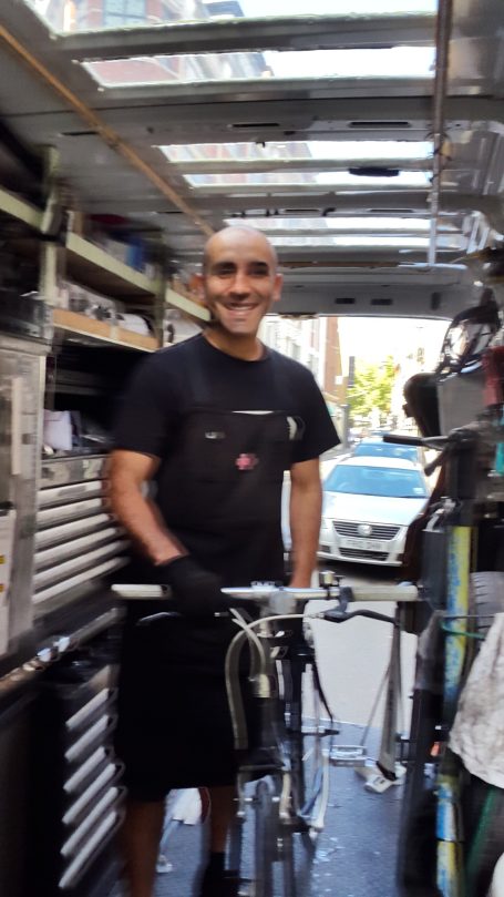 CYCLEDELIK mechanic working inside mobile unit.